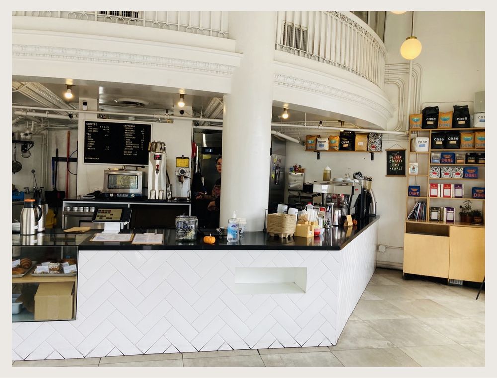 The Highlight Coffee bar interior — herringbone-tiled counter under a vaulted, light-filled rotunda.